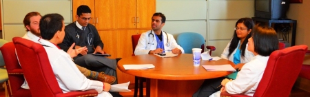 Medical Residents at Table Discussion