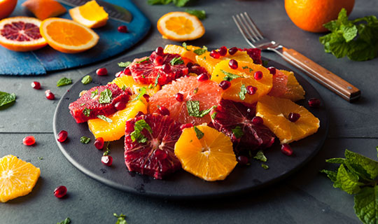 citrus salad - slices of citrus layered over greens topped with mint