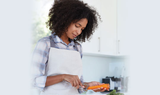 woman peeling carrots in the kitchen