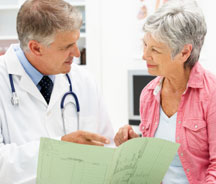Physician going over chart with patient.