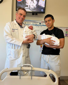 Dr. Bucek and Luis holding babies