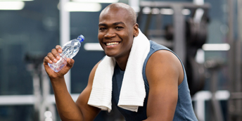 man drinking water post work out