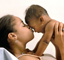 Woman kissing baby's forehead