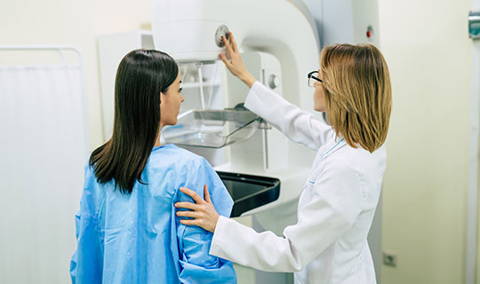 patient talking with physician before getting her mammogram
