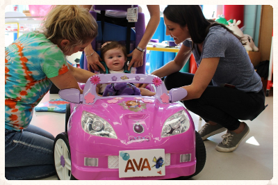 kid in a toy car