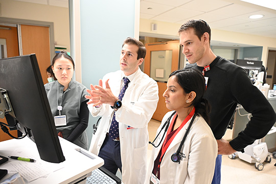 Dr. Nahass leads a discussion with members of the clinical care team at RWJUH