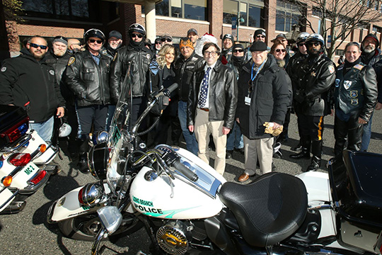 Dr. Zanni and Dr. Teitelbaum gather with riders from the Blue Knights NJ XV and Jersey Shore HOGs and local police departments.