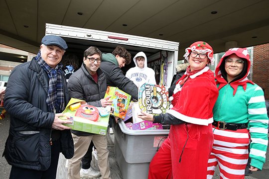 Dr. Zanni and Dr. Teitelbaum lend a hand unloading toys. 