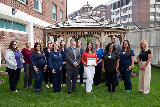 Rebecca Dominguez, BSN, RN is shown with her CCIS team, and Stan Evanowski, LCSW, LCADC, Administrative Director of Behavioral Health Services.