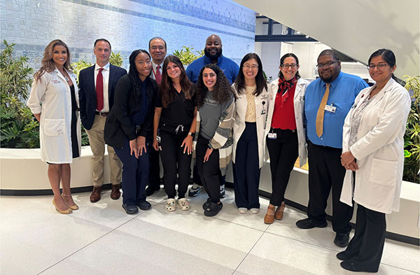 Team of doctors standing in lobby at the Morris Cancer Center