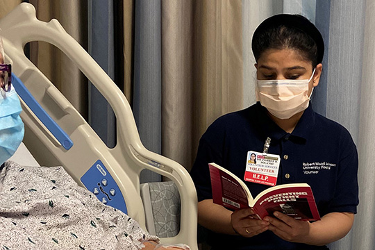 Healthcare worker reading to patient