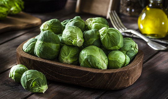 brussel sprouts in a wood bowl