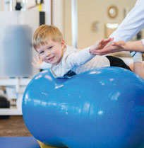 child stretching on a yoga ball