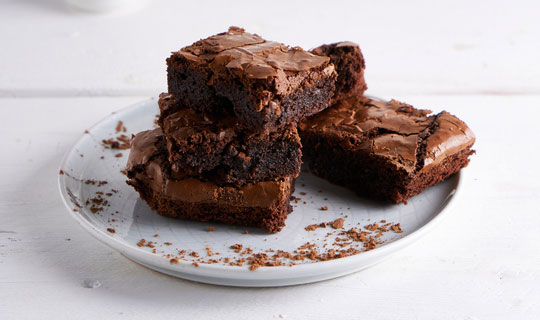 plate with brownies piled up on it