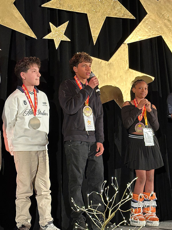 CHoNJ patients Erick Guzman, Jeffrey Delgado and Aubree Walker speaking on stage