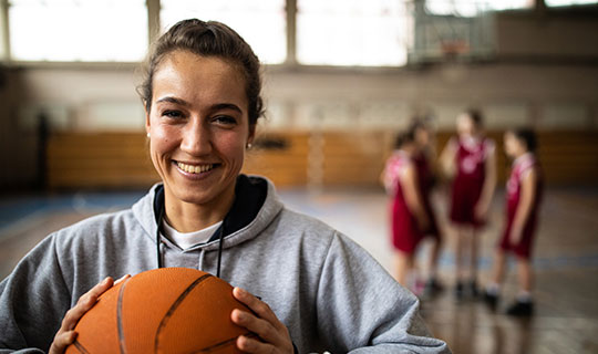 teen girl playing basketball