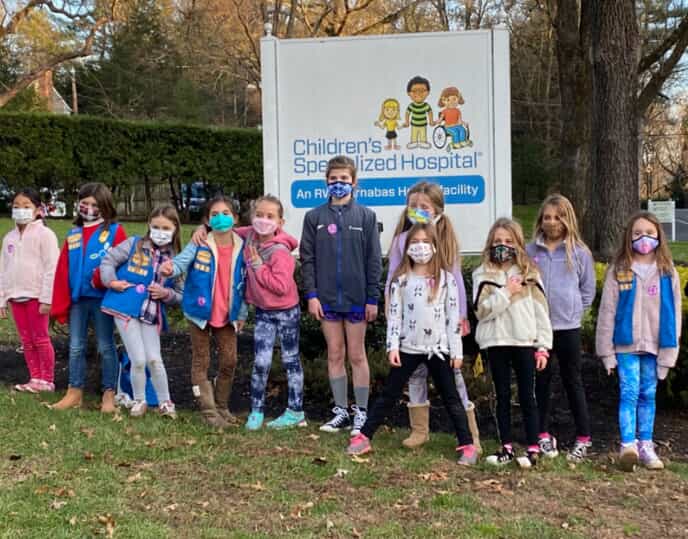 girl scouts wearing masks