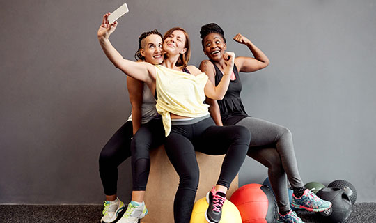 three women having fun exercising