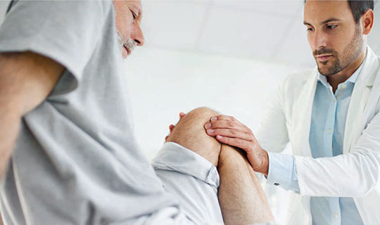 doctor examining a patient's knee