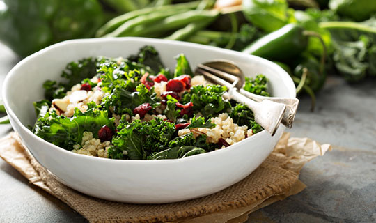 kale, quinoa, and beans in a bowl with a fork