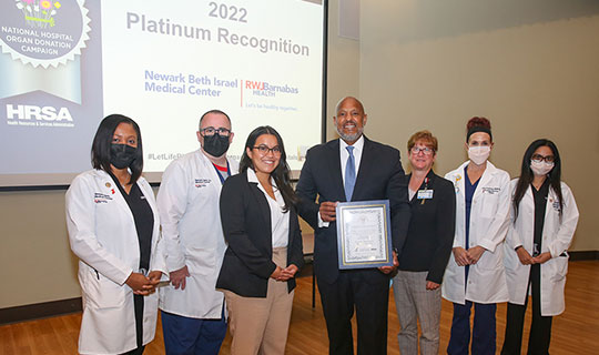 Daniela Padilla presents Darrell K. Terry, Sr. and Amy Doran with HRSA’s Workplace Partnership for Life Hospital Campaign’s 2022 Platinum Award.