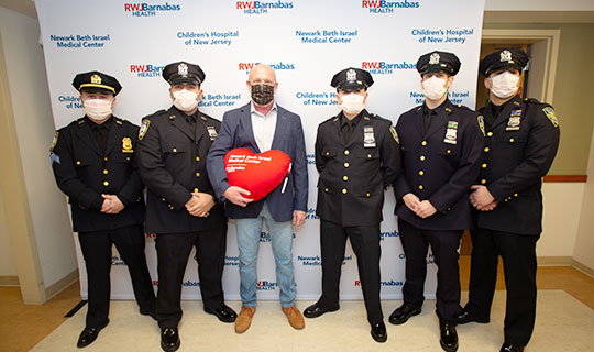 James McFarland with four Port Authority Police Officers who resuscitated him at the airport