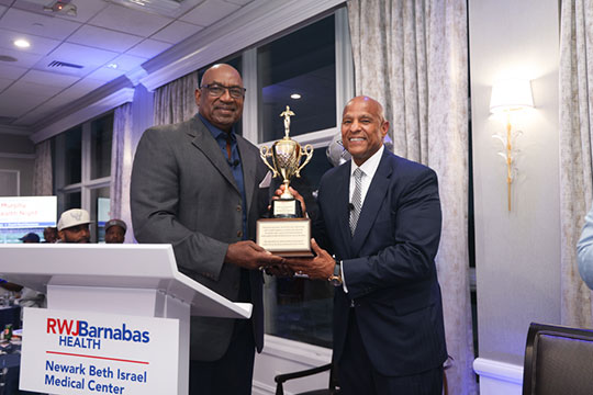 George Martin, Captain, 1986 NY Giants and Super Bowl XXI Champion presented President and Chief Executive Officer of Newark Beth Israel Medical Center and Children’s Hospital of New Jersey’s Darrell K. Terry, Sr., MHA, MPH, FACHE, FHELA,