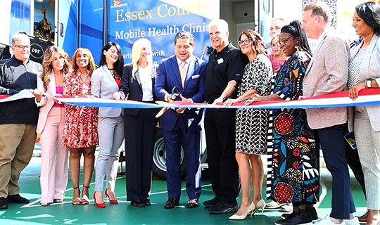 Mark E. Manigan cutting the ribbon for the new pediatric mobile health unit