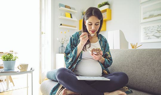 pregnant woman eating a nutritious meal