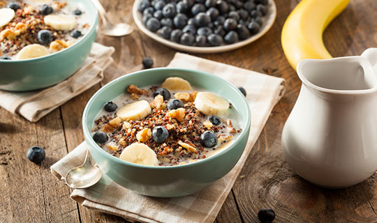 quinoa breakfast bowl with blueberries, hazelnuts, and bananas