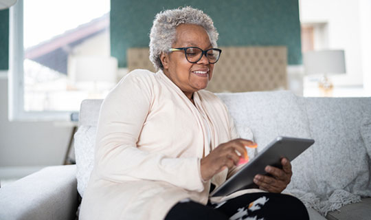 senior woman looking at her tablet