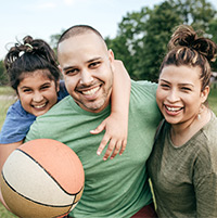 family playing basketball outside