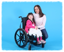 mother kneeling next to daughter in wheelchair 