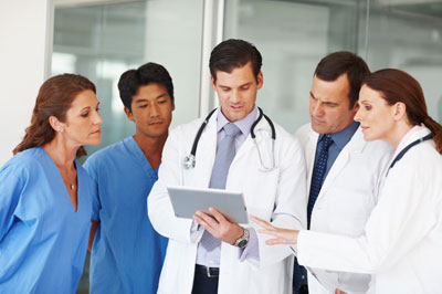 Medical residents reviewing a tablet
