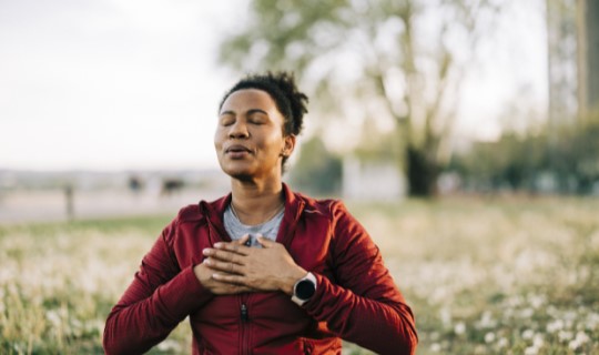Woman taking a deep breath and finding calm in her day
