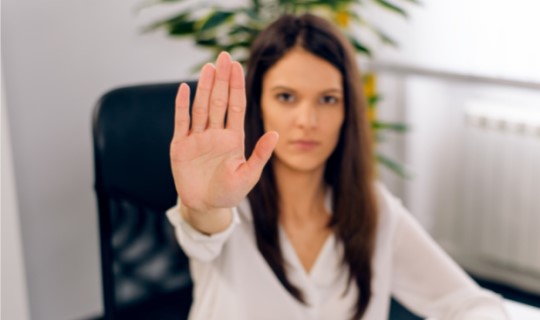 Woman making a "stop" gesture with her hand