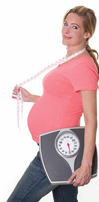 Pregnant Woman Holding Scale