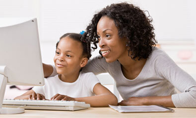 Mother and daughter looking at a computer