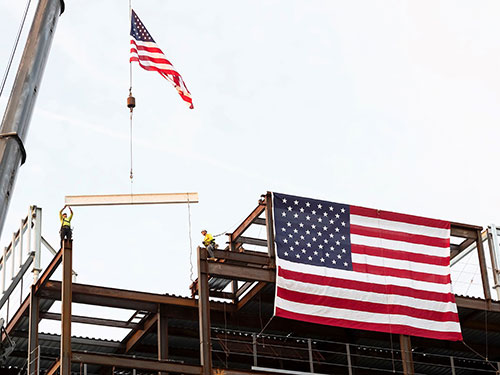 Construction crew members place the final beam in the Specialty and Cancer Care Pavilion at the Vogel Medical Campus in Tinton Falls