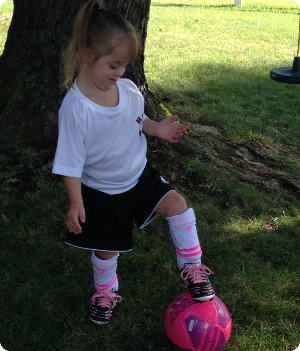 Charlotte playing soccer
