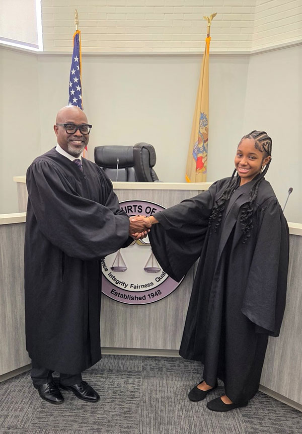 Morgan shaking the hand of the Judge Marshall