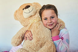 child holding a teddy bear