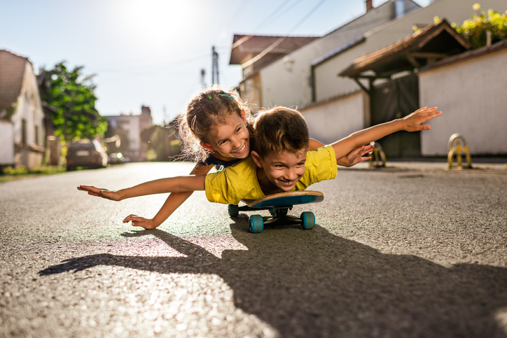 small children on a skateboard