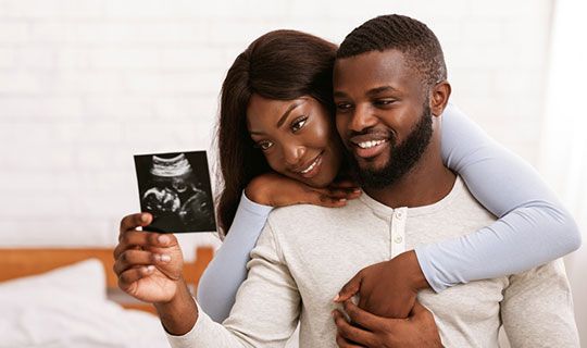 Man and woman with ultrasound image