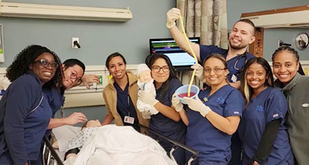 group of nurses in a simulation lab with a baby