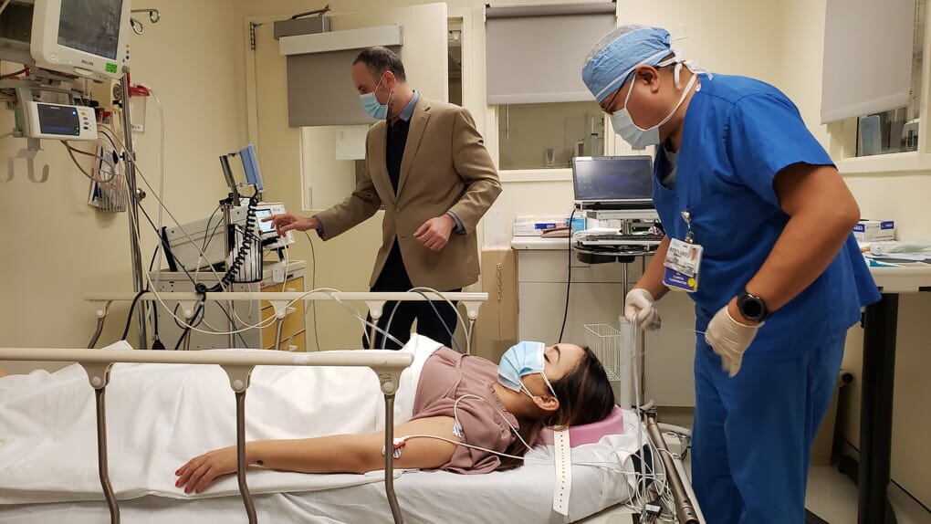 doctor standing over patient