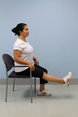 women sitting in a chair with one leg up