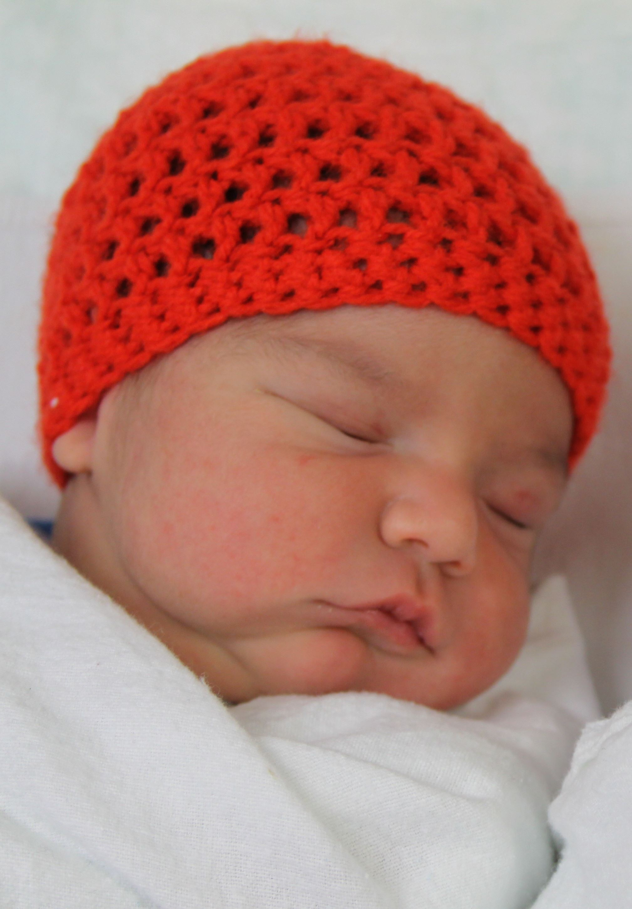 newborn with knitted beanie