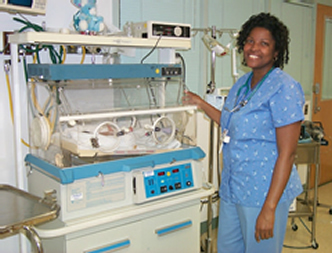 female nurse next to a newborn